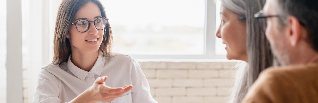 Mature couple speaking with their financial advisor.